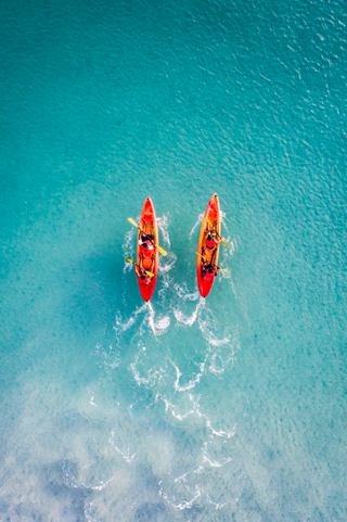 Two people in kayaks enjoying the vibrant turquoise waters of Barbados, embracing adventure and relaxation | MSC Cruises