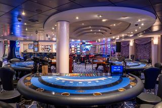A vibrant casino area featuring gaming tables and illuminated decor on the MSC Opera | MSC Cruises