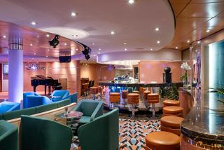 A stylish bar area with comfortable seating and vibrant decor inviting guests to relax and enjoy | MSC Cruises