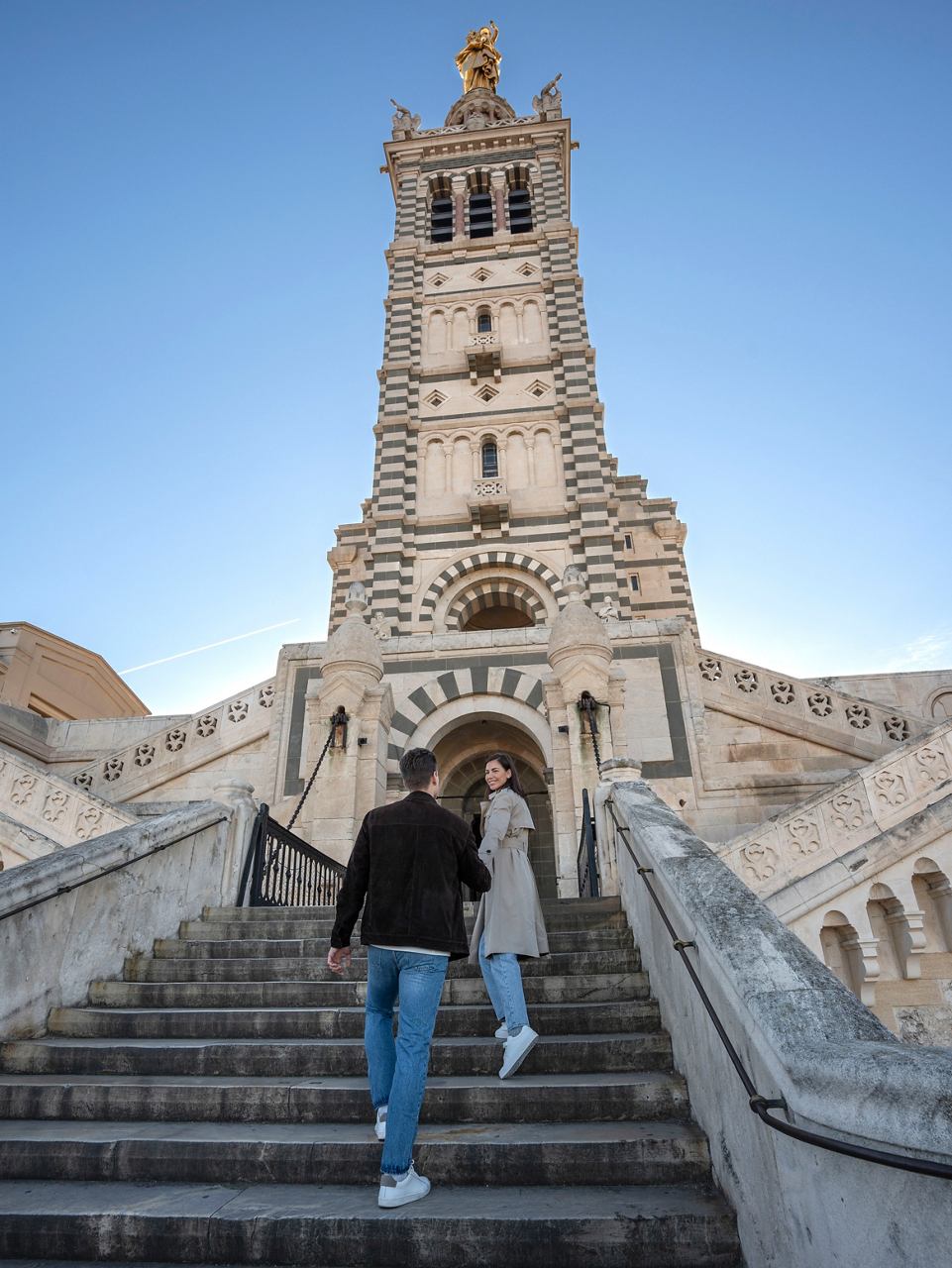 Couple walking up the steps towards the entrance of Notre-Dame de la Garde in Marseille, France | MSC Cruises