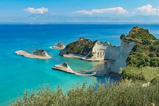 Breathtaking view of Cape Drastis showcasing cliffs and a vibrant coastline along the serene waters of Corfu | MSC Cruises