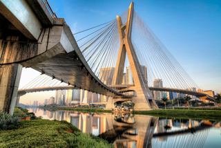 A stunning view of the Estaiada Bridge reflecting on the water, showcasing the vibrant São Paulo skyline | MSC Cruises
