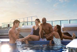 A group of friends enjoying time together in the Long Island Pool on the MSC Seashore | MSC Cruises