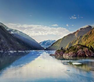 Serene lake surrounded by majestic mountains and glaciers in Tracy Arm, Alaska | MSC Cruises