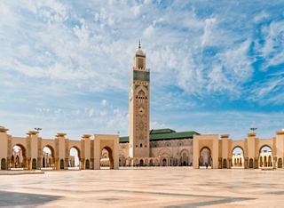 The majestic Hassan II Mosque stands tall against a bright sky, showcasing its stunning architecture in Casablanca | MSC Cruises