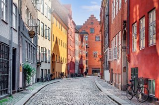 A vibrant Copenhagen street lined with colourful buildings, inviting exploration and discovery | MSC Cruises