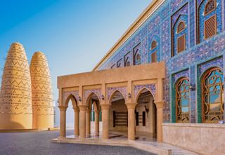 The stunning architecture of the Katara Mosque in Doha, Qatar, showcasing intricate arches and vibrant colours | MSC Cruises