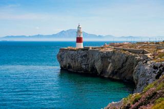 A stunning lighthouse stands at Europa Point, overlooking the tranquil sea and cliffs of Gibraltar | MSC Cruises