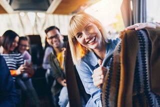 A group of travelers smiles together, ready to embark on their bus journey | MSC Cruises