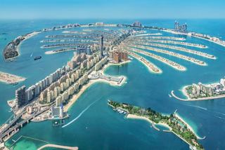 A stunning aerial view of Dubai Marina and Palm Jumeirah, showcasing the vibrant coastal architecture and inviting sea | MSC Cruises
