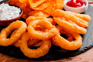 A platter of crispy onion rings served with sauces at the sports bar on MSC Divina | MSC Cruises