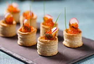 A selection of elegant salmon appetizers garnished with herbs, served at the MSC Seaview Champagne Bar | MSC Cruises