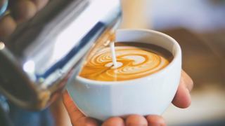 A barista skillfully pours cappuccino into a bowl, showcasing the rich texture | MSC Cruises