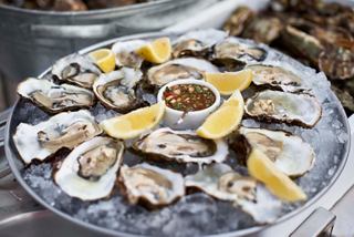A platter of fresh oysters garnished with lemon slices, inviting you to indulge in a culinary experience | MSC Cruises