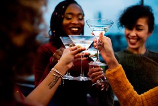 Friends toasting with drinks in a lively atmosphere, celebrating moments together at the Haven Lounge | MSC Cruises