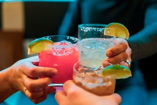 A joyful group toasting with colourful cocktails at the Jungle Pool Beach Bar onboard MSC Seashore | MSC Cruises