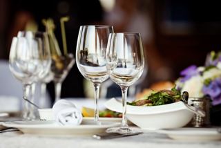 An elegant dining setup with glasses and a beautifully arranged plate, inviting guests to enjoy a delightful meal | MSC Cruises
