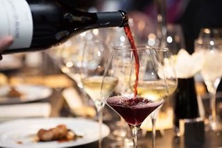 A rich red wine being poured into a glass, ready to complement a delightful meal | MSC Cruises