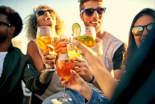 A group of friends enjoying vibrant cocktails together on a sun deck, celebrating their time on MSC Seascape | MSC Cruises