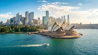 Aerial view of Sydney showcasing the iconic Opera House and city skyline beside the sparkling sea | MSC Cruises