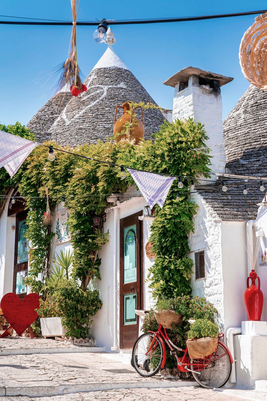 Incantevoli case trulli ad Alberobello, Italia, circondate da una vegetazione vivace e fiori | MSC Crociere