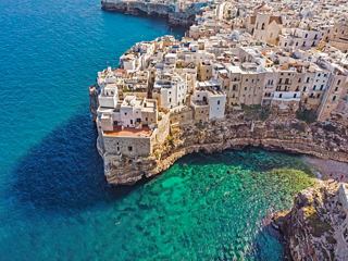 Aerial view of cliffside houses in Polignano a Mare, overlooking the Mediterranean Sea | MSC Cruises
