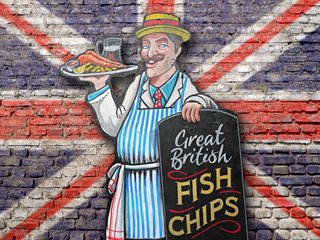 A cheerful vendor holding a sign for fish and chips in front of a British flag backdrop | MSC Cruises