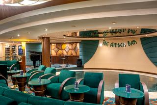 A welcoming lounge area with comfortable seating, a stage, and a piano, perfect for relaxation and entertainment | MSC Cruises