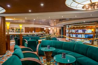 A stylish lounge area featuring plush seating and a welcoming bar counter, perfect for relaxation and socialising | MSC Cruises