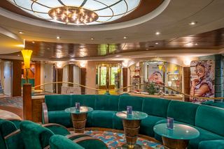 A vibrant lounge area with comfortable seating and tables, perfect for relaxation and socialising | MSC Cruises