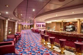 A welcoming lounge area featuring comfortable seating and a stylish bar counter for relaxation | MSC Cruises
