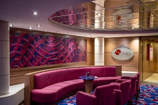 A stylish and inviting lounge area with plush seating and vibrant decor on the MSC Orchestra | MSC Cruises