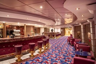 A welcoming lounge area featuring comfortable seating and a stylish bar counter for relaxation and socialising | MSC Cruises