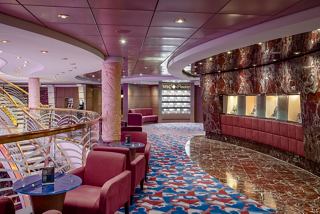 Elegant seating area in Zaffiro Bar, featuring rich colours and a welcoming atmosphere for relaxation | MSC Cruises