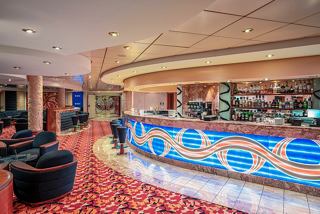 A welcoming bar area with a vibrant counter and comfortable seating for guests to relax and enjoy beverages | MSC Cruises