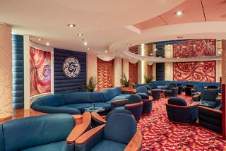 A welcoming lounge area of L'Incontro Bar on MSC Orchestra with comfortable seating and vibrant decor | MSC Cruises