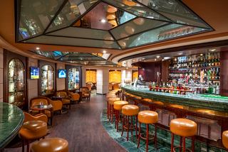 A vibrant bar area with seating and a welcoming atmosphere on MSC Orchestra | MSC Cruises
