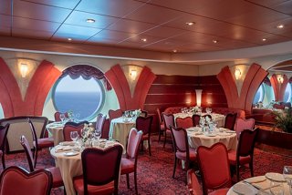 A stylish dining area with elegant seating, portholes, and sea views invites guests to enjoy their meals | MSC Cruises