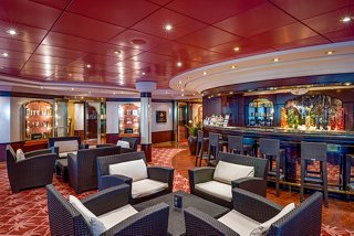 A cosy lounge area with comfortable seating, warm colours, and a welcoming atmosphere for relaxation | MSC Cruises