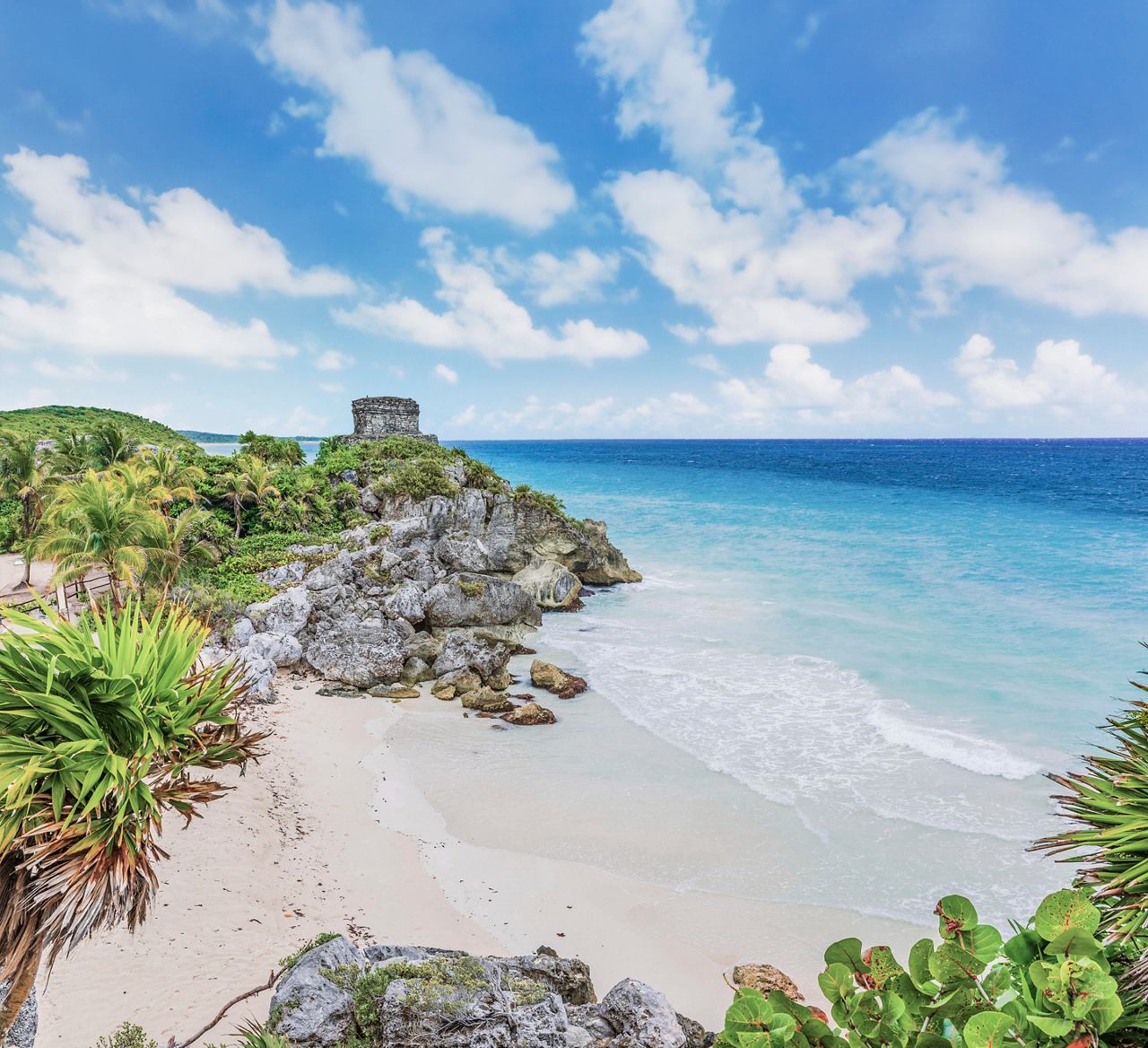 Tranquil Caribbean sea surrounded by lush rocks and white sandy beaches | MSC Cruises