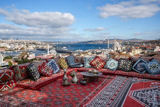 Rooftop café overlooking the Bosphorus with guests enjoying tea and pastries against a stunning Istanbul panorama | MSC Cruises