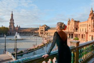 A woman gazes at the stunning architecture along the waterfront in Cadiz, Spain, capturing the essence of Mediterranean beauty | MSC Cruises
