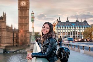 A woman enjoys the view of Big Ben from a bridge in London during a beautiful sunset | MSC Cruises