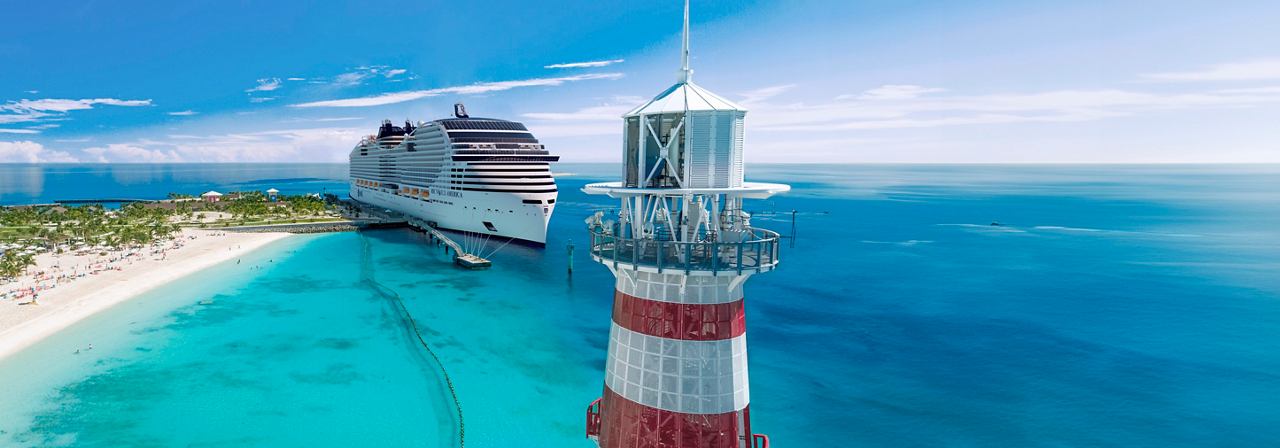 An aerial view of MSC World America near a lighthouse in the Bahamas Ocean Cay MSC Marine Reserve | MSC Cruises