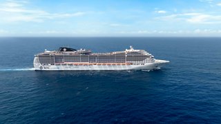 Aerial view of the MSC Preziosa cruising on the sea under a clear sky | MSC Cruises