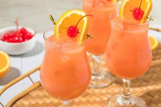 Refreshing cocktails garnished with orange slices and cherries, perfect for enjoying on board | MSC Cruises