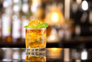 A refreshing Mai Tai cocktail garnished with orange and lime, set on a bar at Le Vele on MSC Fantasia | MSC Cruises
