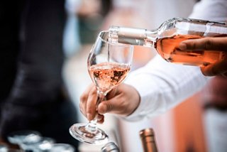 Elegant glasses of rosé wine are raised in celebration at L'etoile Restaurant on MSC Fantasia | MSC Cruises