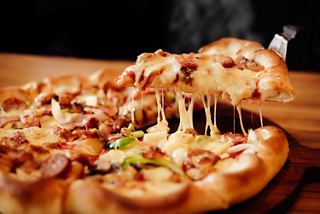 A delicious slice of pizza topped with melted cheese and ingredients, ready to be enjoyed at the MSC Preziosa buffet | MSC Cruises