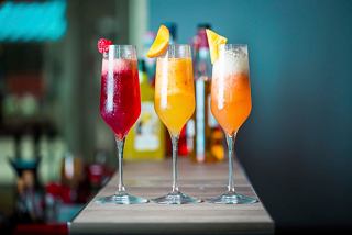 A vibrant selection of colourful cocktails garnished with fruit at The Green Sax bar | MSC Cruises
